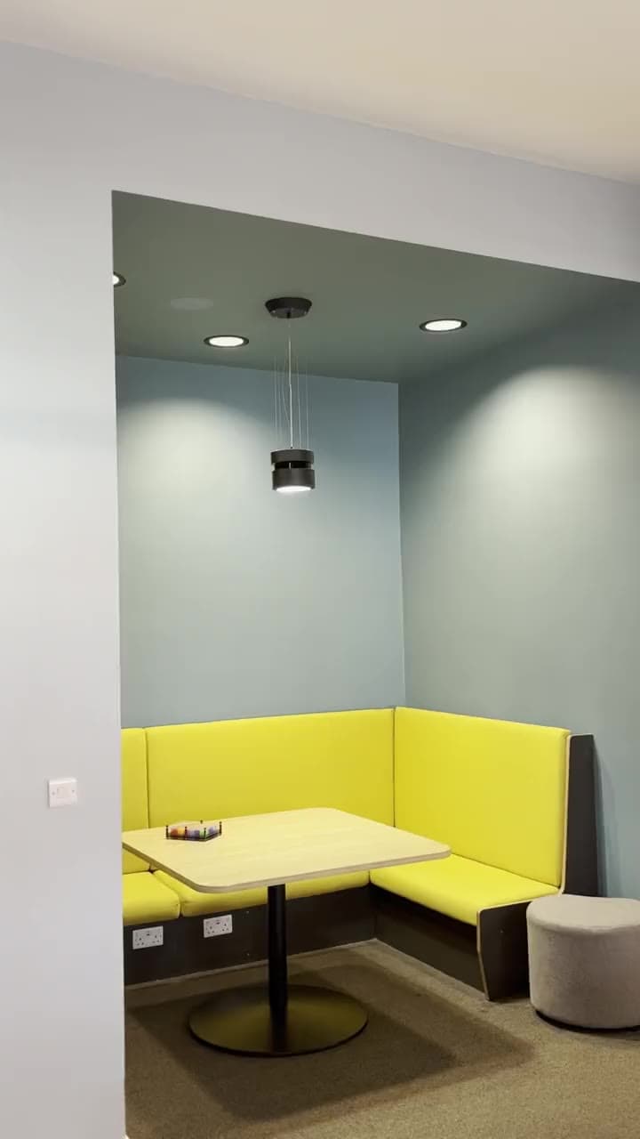 A communal space at Broadgate Park with a yellow booth and table